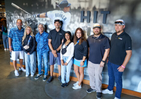 People standing in front of a baseball wall mural