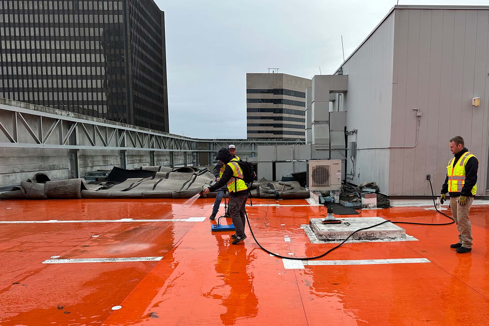 workers testing for water leaks in building membrane